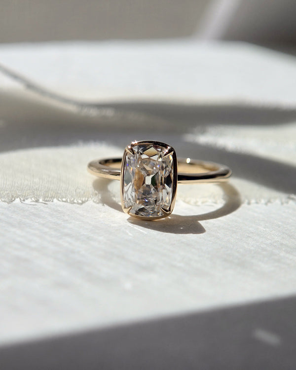 Front view of The Odette with an elongated Old Mine cushion-cut lab-grown diamond in a four-prong yellow-gold bezel setting.